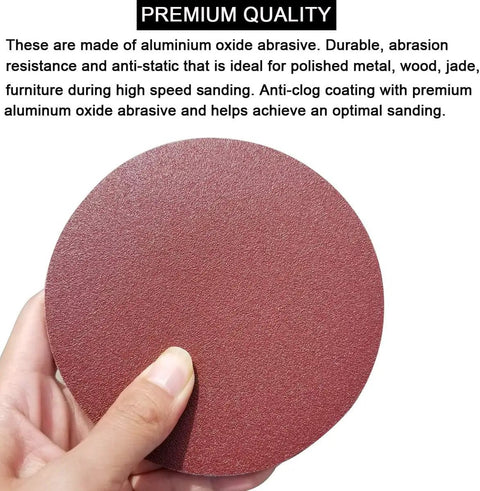 Hand holding a 5 Inch PSA Sanding Disc with aluminum oxide grain for DA sander, part of 5 Inch PSA Sanding Discs Set With 60 Pieces Ten Each Of 80 100 120 180 240 And 400 Grit Self Adhesive Sticky Back For DA Sander Great For Car Paint Prep Woodworking And Metal Shaping