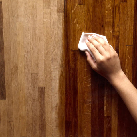 Hand applying Deep Penetrating Food Grade Butcher Block Conditioner For Hardwood And Bamboo Surfaces That Revitalizes Wood