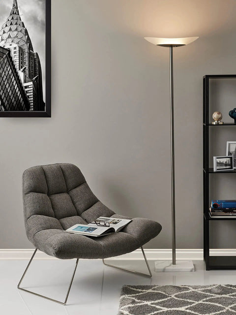 Celeste 71 Inch LED Torchiere Floor Lamp With Marble Base and Frosted Glass Shade in living room corner by chair.