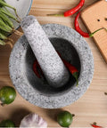 Unpolished Granite Mortar And Pestle Set With Silicone Lid 2 Cup Capacity Garlic Peeler Non Slip Pad 5.5 Inch Spice Grinder on table