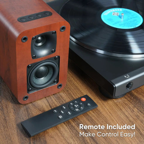 Powered Bluetooth Bookshelf Speakers With 40W Output, 2.75-Inch Woofer, next to turntable, remote control visible