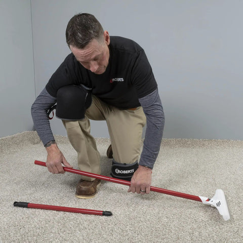 Man using 12 Inch Carpet Rake And Groomer With 51 Inch Reach Handle For Deep Clean Loosens Embedded Soil And Hair From Cut Pile Carpets Before Vacuuming, Big 12 Inch Head Cleans Fast Cold Rolled Steel Handle Polypropylene Head Nylon Bristles indoors