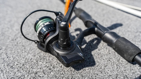 Close-up of 6 Ft 6 In Max SX Spinning Rod And Reel Combo Size 3000 with 7 stainless steel ball bearings on a boat deck