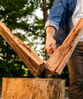 Top Shelf 14 Inch Wood Splitting Maul With Forged Steel Head and Kickless Grip splitting wood in action outdoors.