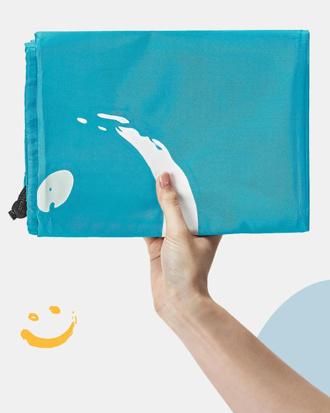 Hand holding Extra Large 2 Pack Laundry Bags 28 By 40 Inches Heavy Duty Drawstring Laundry Organizers in sky blue