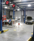 Heavy Duty Built Tough 50 Foot Retractable Extension Cord Reel With Three Grounded Outlets in a garage workshop setting