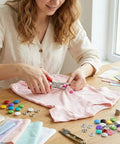 Person using pliers to install colorful alloy snaps on fabric, showcasing 200 Pieces 9.5mm Alloy Snap Button Kit For Fabric Sewing Colorful Fasteners For Clothing Hats And DIY Crafts Easy Install Durable Rust Resistant Alloy Snaps Great For Upcycling Garments And DIY Projects.