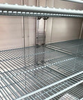Interior view of wire racks in the Top Shelf Commercial 3 Door Reach In Refrigerator, Built Tough Stainless Steel Display Cooler.