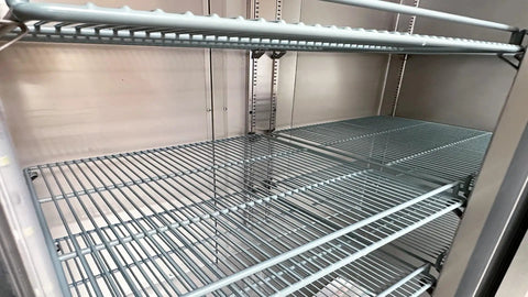 Interior view of wire racks in the Top Shelf Commercial 3 Door Reach In Refrigerator, Built Tough Stainless Steel Display Cooler.