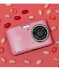 Easy Peasy Pastel Pink 16MP Point And Shoot Camera With 1080P Full HD Video on pink background with jellybeans.