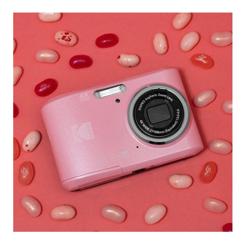 Easy Peasy Pastel Pink 16MP Point And Shoot Camera With 1080P Full HD Video on pink background with jellybeans.