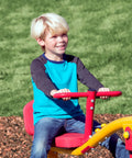 Child playing on Spinning Teeter Totter Playground Set For Kids 360 Degree Rotation Teeter Totter with red seat outdoors