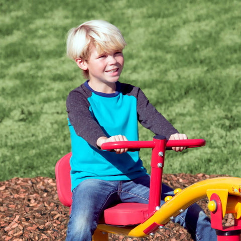Child playing on Spinning Teeter Totter Playground Set For Kids 360 Degree Rotation Teeter Totter with red seat outdoors