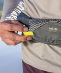 Close-up of the USCG Approved Manual Inflatable Belt Pack With Low Profile And 52 Inch Waist Fit on person's waist, showing M16 label.
