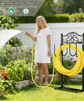 Built Tough Heavy Duty Garden Hose Holder With Four Stabilizing Spikes Freestanding Metal Hose Stand For Up To 100 Ft Of Hose Yard Lawn And Outdoor Garden Black in garden with woman watering plants