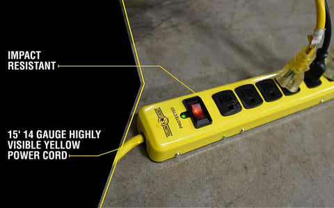 Beefy Metal Surge Protector Strip With Six Outlets And 15 Foot Yellow Cord, shown with connected plugs on workshop floor.