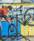 Heavy Duty Bike Repair Stand for Easy Home Maintenance, Height Adjustable and Foldable Bike Work Stand With Tool Tray in use