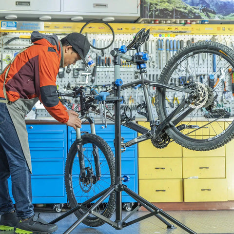 Heavy Duty Bike Repair Stand for Easy Home Maintenance, Height Adjustable and Foldable Bike Work Stand With Tool Tray in use