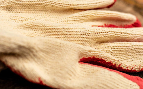 Close-up of Economical String Knit Latex Dipped Palm Gloves With Nitrile Coated Fingers For General Purpose Work, showing knit texture.