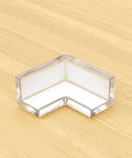 Hella Secure Baby Proofing Pack Featuring Clear Pvc Edge And Corner Guards strong corner bumper on wooden table for toddler safety.