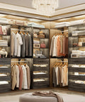 Rock Solid Black Oak L Shaped Closet Organizer System With Twelve Super Spacious Drawers And Four Expandable Hanging Rods Makes Walk In Storage A Total Breeze, featuring stylish clothing and organized shelves.