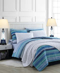 Set Of 2 Modern Ceramic Table Lamps With Touch Control And Built In Outlet Dual USB Ports No Fuss Convenience Ideal For Living Room Or Bedroom Nightstands Warm 2700K Lighting White Textured Ceramic With Linen Drum Shade beside bed with striped bedding.