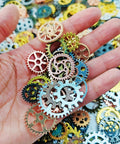 Hand holding 300g Assorted Color Antique Metal Steampunk Gears Charms Pendants For DIY Jewelry Making And Crafting Accessories