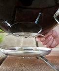 Close-up of ash catcher on Smokey Joe 14 Inch Portable Charcoal Grill With Tuck N Carry Lid Lock And Durable Porcelain Enamel Finish