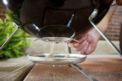 Close-up of ash catcher on Smokey Joe 14 Inch Portable Charcoal Grill With Tuck N Carry Lid Lock And Durable Porcelain Enamel Finish