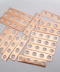 Top Shelf 16 Piece Purple Copper Battery Bus Bar Connection Plates For 5.5 6.2 And 6.9 Ah Lithium Cells, showing 16 copper plates with four holes each.