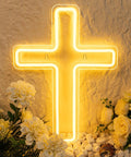 Lit Cross LED Neon Sign for Wall Decor USB Powered Glow Light for Bedroom on stone wall with flowers below