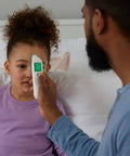 TempleSwipe Digital Thermometer With Color Coded Fever Guide Backlit Display For Adults And Kids Fast Accurate Readings No Fuss Temple Swipe Check Green Yellow Red Fever Indicators Kid Friendly forehead thermometer held to child's temple