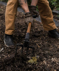 Gardener using foldable spading fork for digging and aerating durable steel garden tool with easy twist lock, in soil