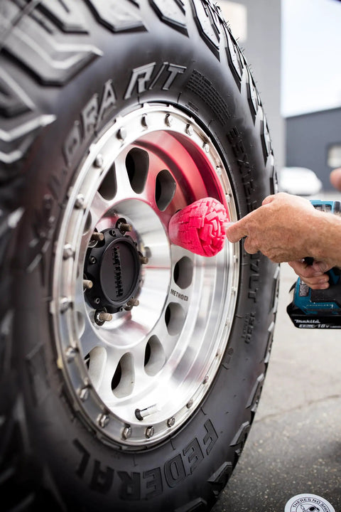 PowerCone 360 Polishing Tool with quick swap bit in use on truck wheel, showing wheel guard protecting edges and spokes.