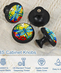 Colorful dragonfly pattern ABS cabinet knobs with glass crystal covers on fabric background.