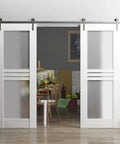 Modern Double Barn Door Set With 4 Lite Panels And 13 Ft Silver Rail Track Includes 2 Solid Interior Slabs And Full Sliding Hardware Kit For An Easy Install shown in a living room