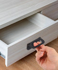 Hand using 4 Pack Flush Pull Handles Set For Cabinets And Drawers, 3 Inch Hidden Recessed Grip, Gold Finish on wooden drawer
