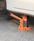 VEVOR hydraulic jack, orange steel toe lift, side view under a car.