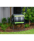 Dual Compartment 48 Gallon Compost Tumbler With Easy Turning Geared Design placed in a garden setting for composting.