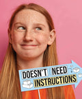 Girl smiling with sign saying 'Doesn't Need Instructions' at a birthday photo booth for Awesome Funny Building Blocks Birthday Photo Booth Prop Kit