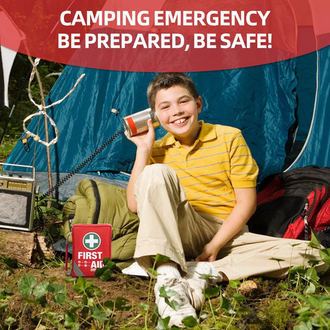 General Medi first aid kit, red compact bag with white cross emblem, placed beside a boy at a campsite.