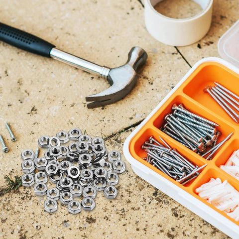 Top Shelf 50 Pack Stainless Steel Hex Nuts With Coarse Thread built tough with hammer and assorted screws in DIY workshop.