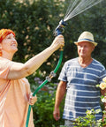 Person using garden hose with spray nozzle, with 2 Pack Garden Hose Repair Kit With Hose End Mender Set installed, outdoors