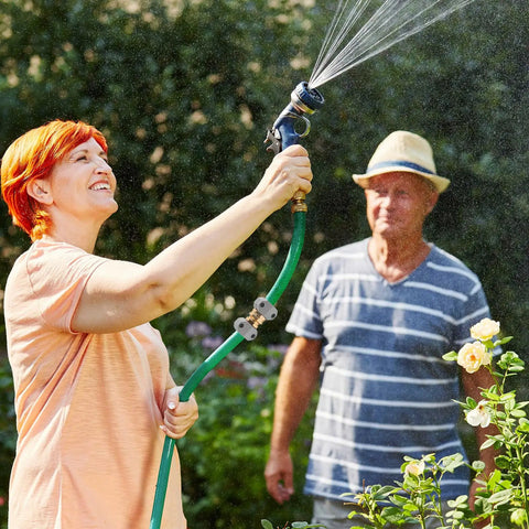 Person using garden hose with spray nozzle, with 2 Pack Garden Hose Repair Kit With Hose End Mender Set installed, outdoors