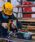 Worker using Oxy Acetylene Welding Hose 50 Feet Long With One Quarter Inch Inner Diameter And B Fitting Twin Cutting Torch Hose.