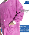 Close-up of pink 50 pack disposable lab coats for adults hip length with pockets and knit cuffs 45gsm SMS multi layer fabric