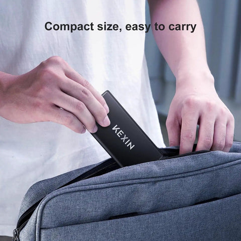 Person placing 256GB USB 3.1 Type C External SSD Drive Portable Solid State Storage into a bag, highlighting compact size.