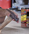 Boss Level Liquid Epoxy Adhesive For Ultimate Waterproof Fixes And Leak Plugging With Six Thousand Psi Anchor Hold Takes Crazy Intense Heat Up To Five Hundred Fifty Degrees Super Fast Set Bonds Knockout Strong On Metal Or Plastic In A Compact Black with hammer in hand.