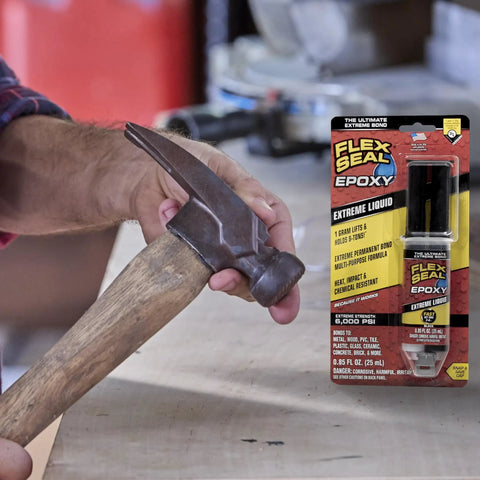 Boss Level Liquid Epoxy Adhesive For Ultimate Waterproof Fixes And Leak Plugging With Six Thousand Psi Anchor Hold Takes Crazy Intense Heat Up To Five Hundred Fifty Degrees Super Fast Set Bonds Knockout Strong On Metal Or Plastic In A Compact Black with hammer in hand.