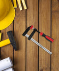 Solid Heavy Duty 6 Inch Metal Bar Clamp With Quick F Handle Adjusts Fast For One Hand Woodworking DIY Welding Rust Proof Construction Projects on wooden surface with tools.